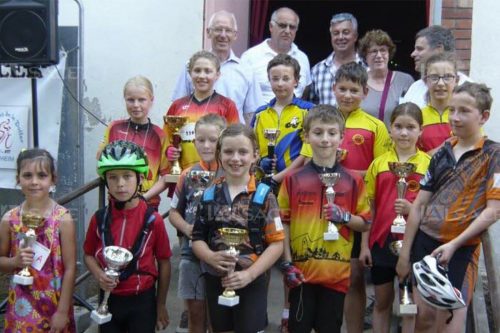 Photographie d'un groupe d'enfant avec des trophées dans les mains